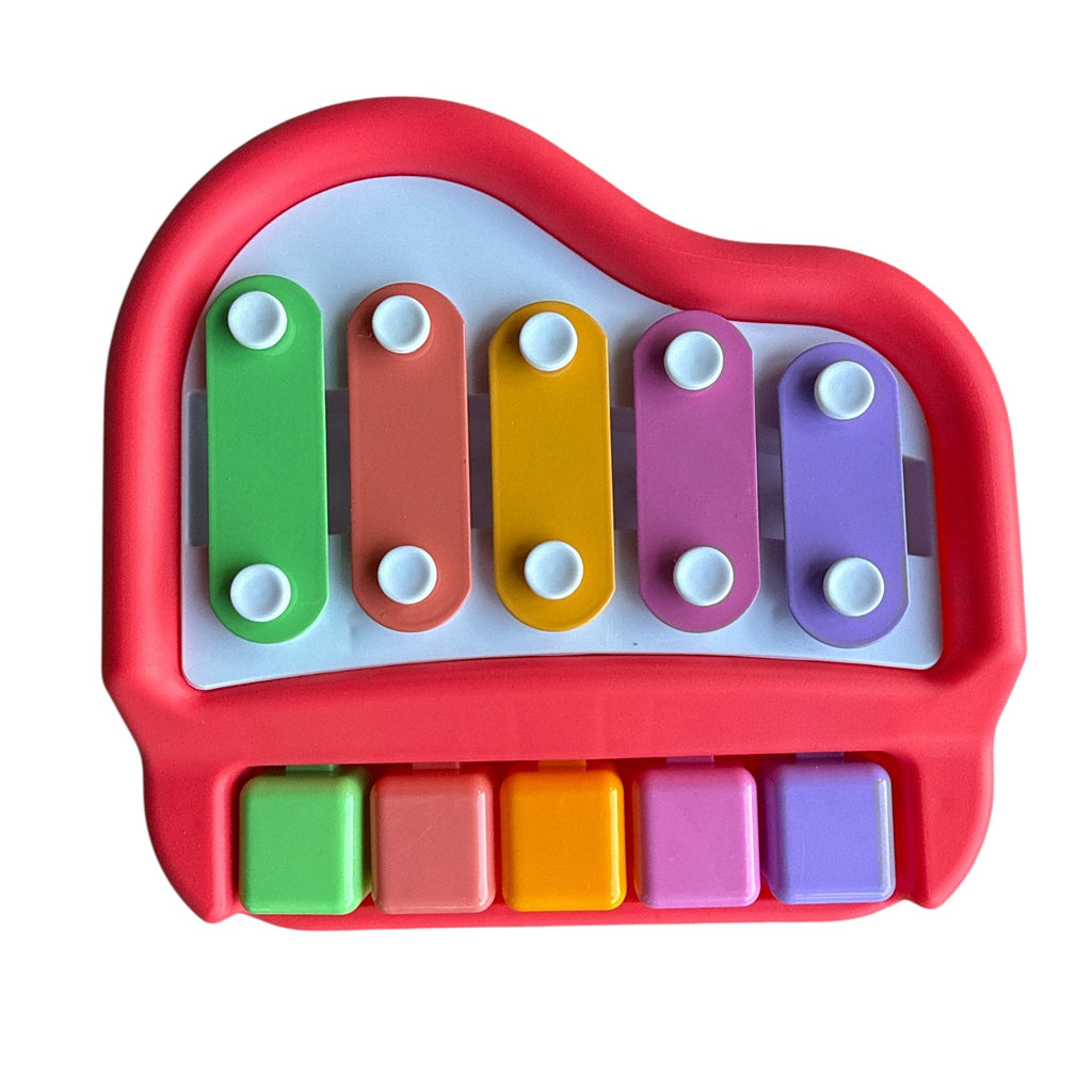 Colorful toy piano with red casing on a white background