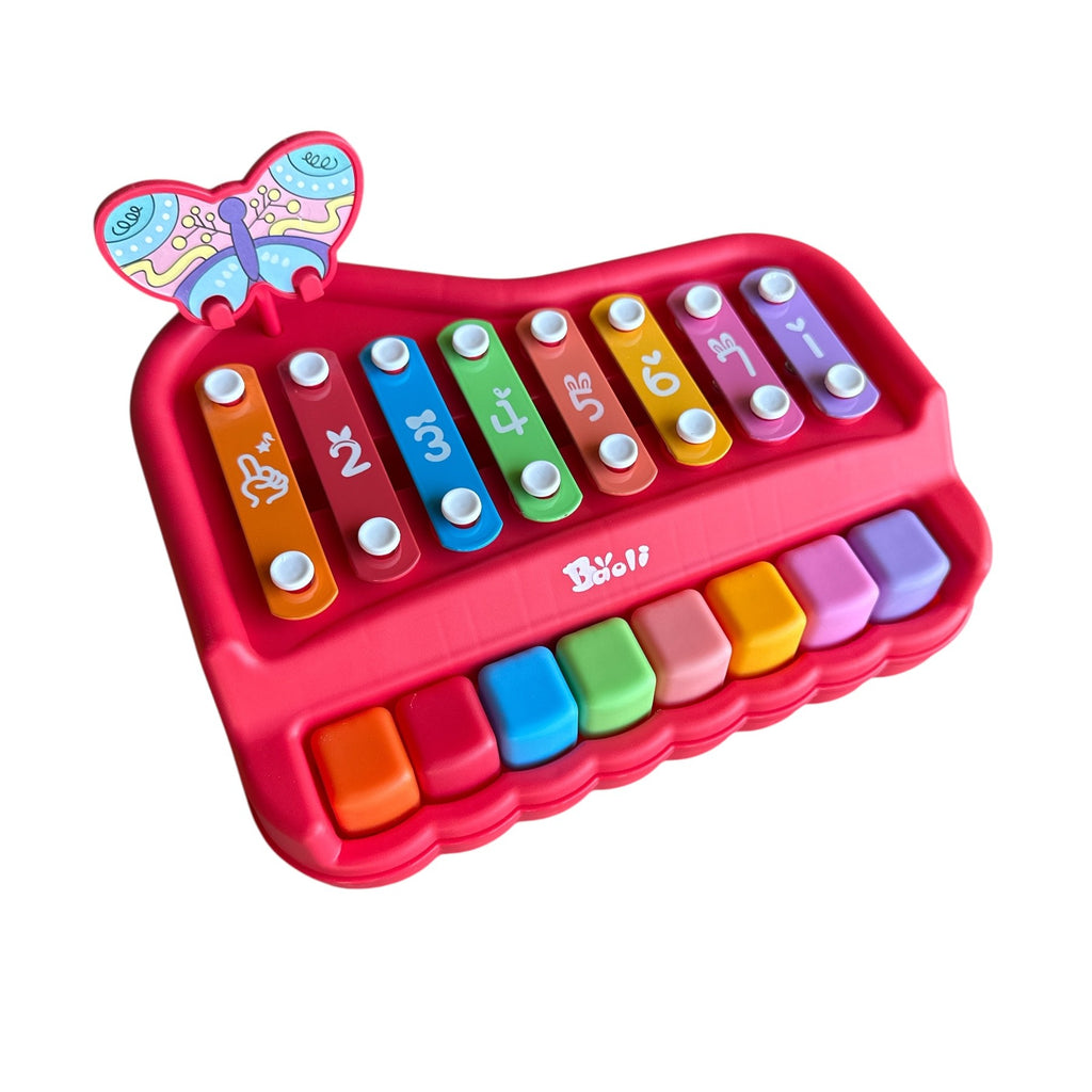 Colorful toy keyboard with butterfly design on a white background