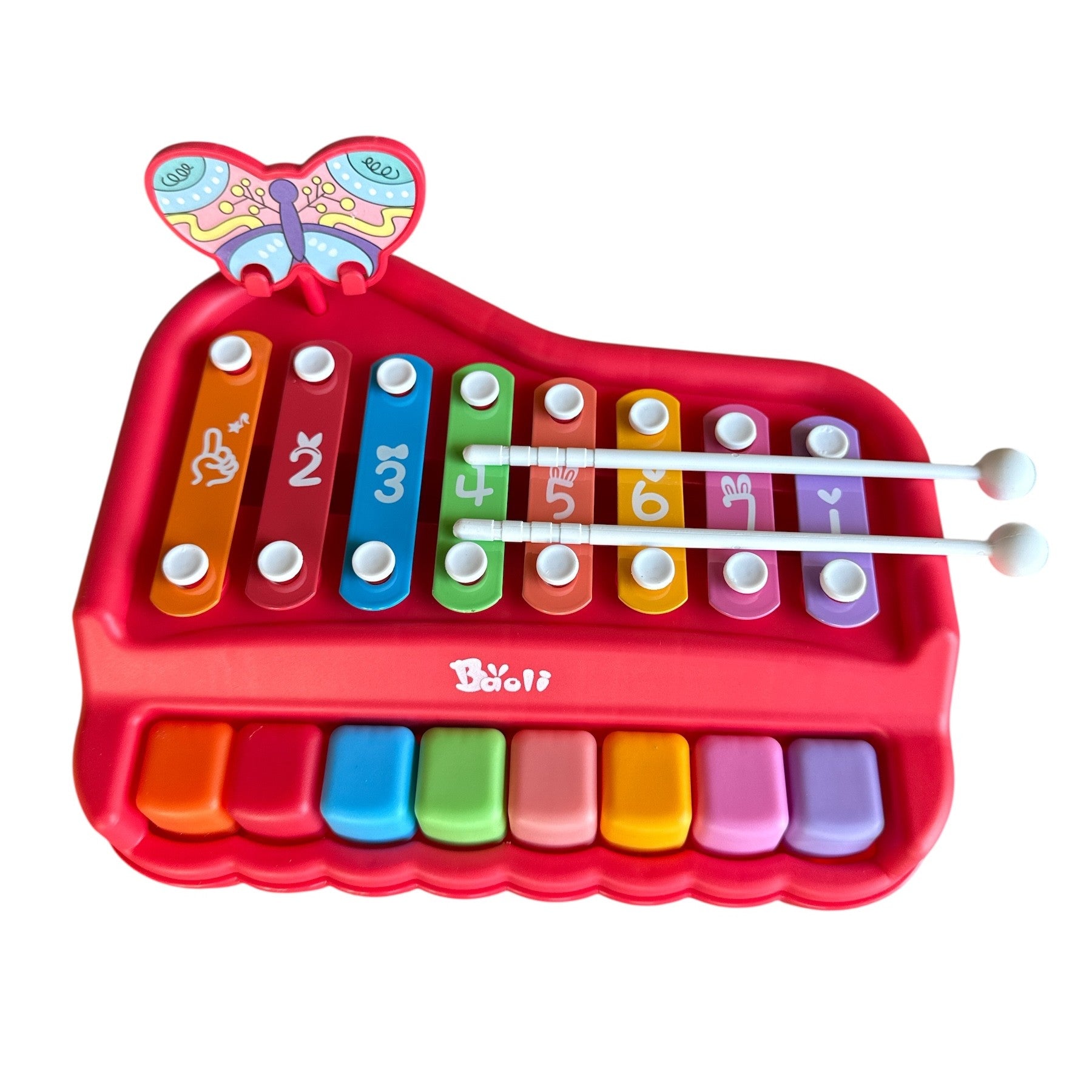 Colorful toy piano with butterfly design on a white background