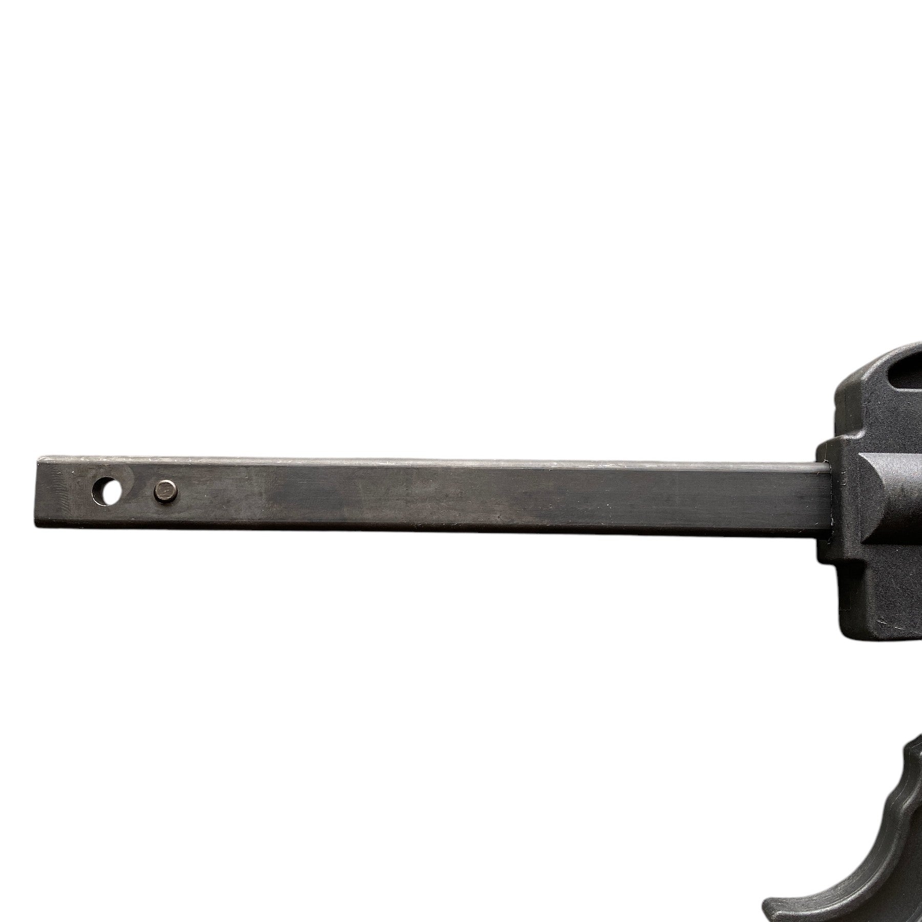 Metallic object with a long bar and cylindrical component on a white background