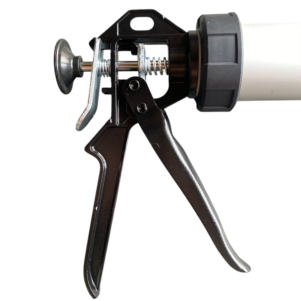 Close-up of a caulking gun on a white background
