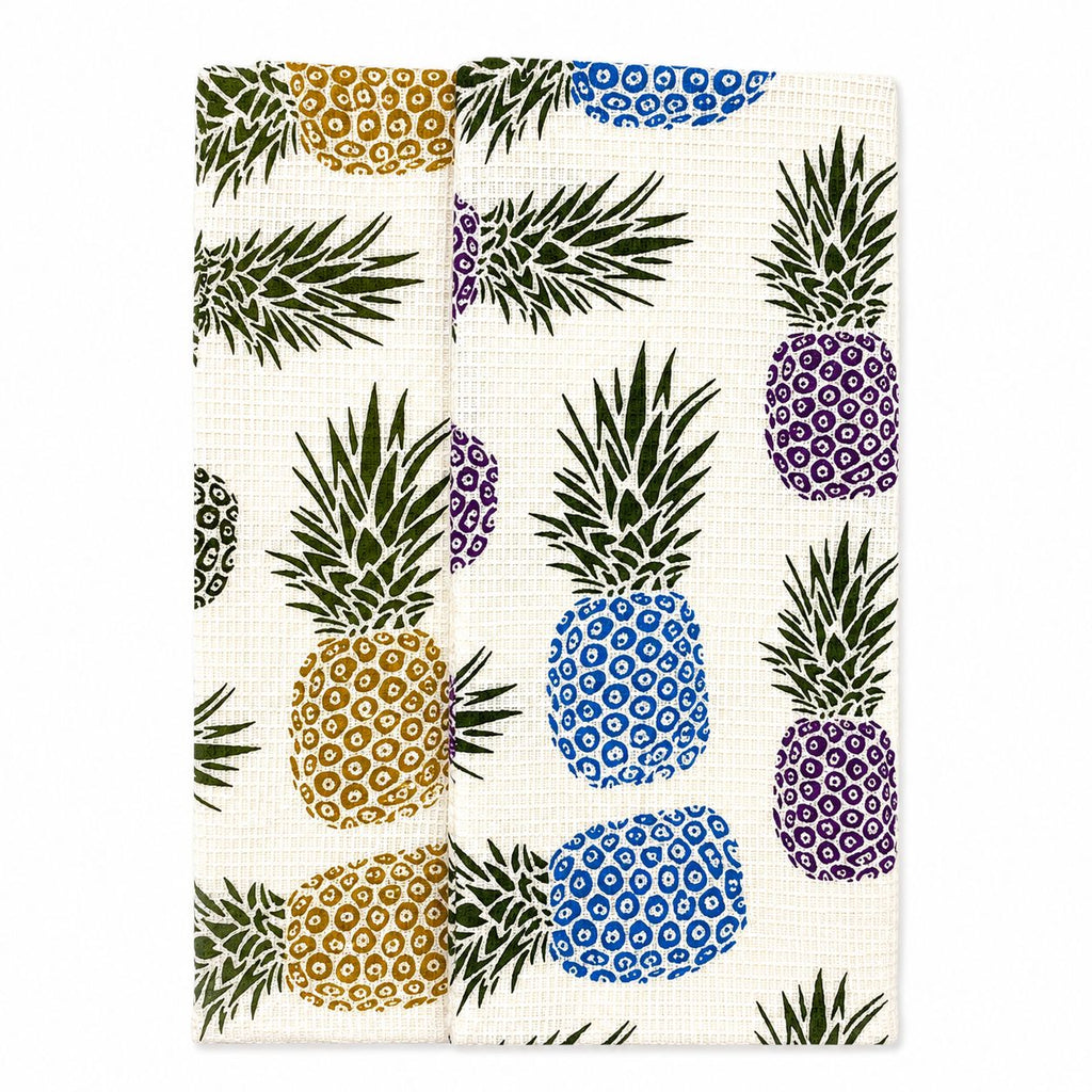 Patterned fabric with colorful pineapples on a white background