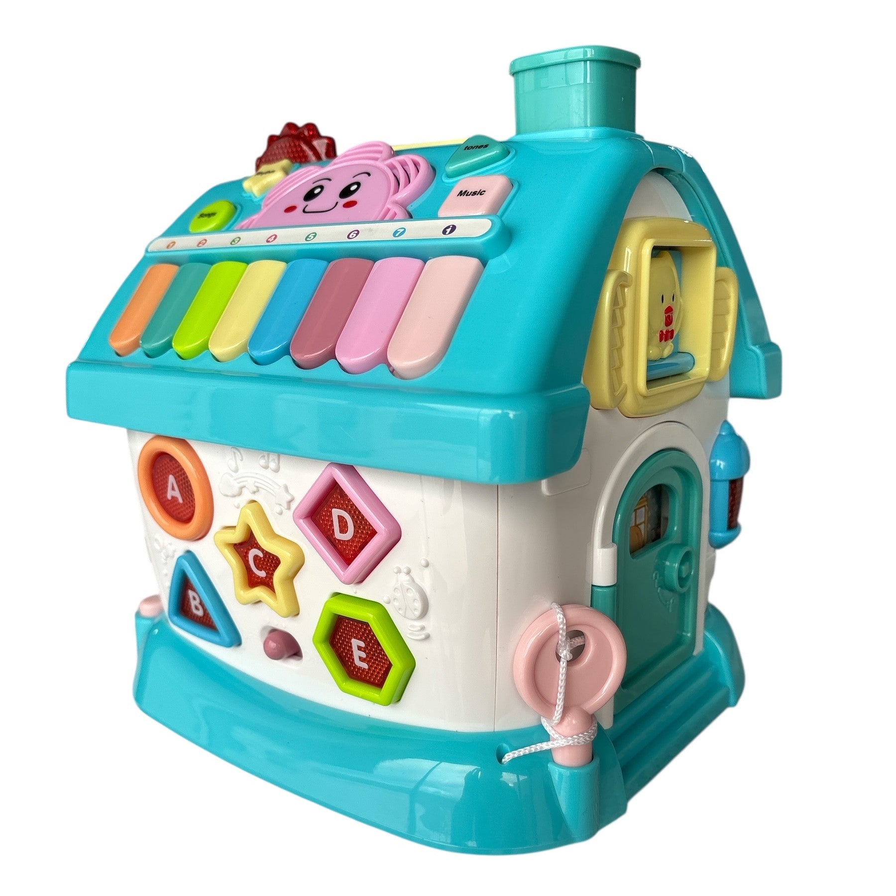 Colorful toy house with piano keys and alphabet letters on a white background