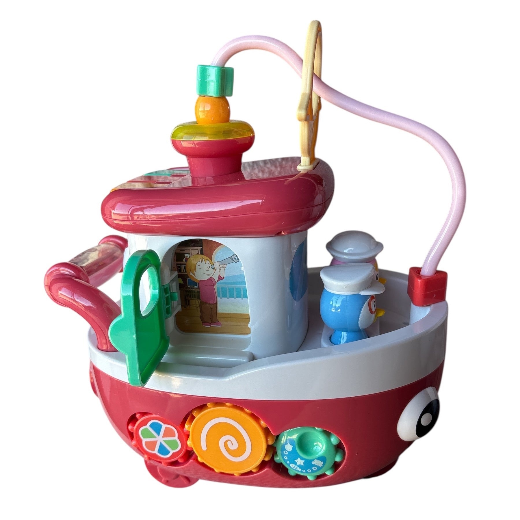 Colorful toy boat with various interactive elements on a white background