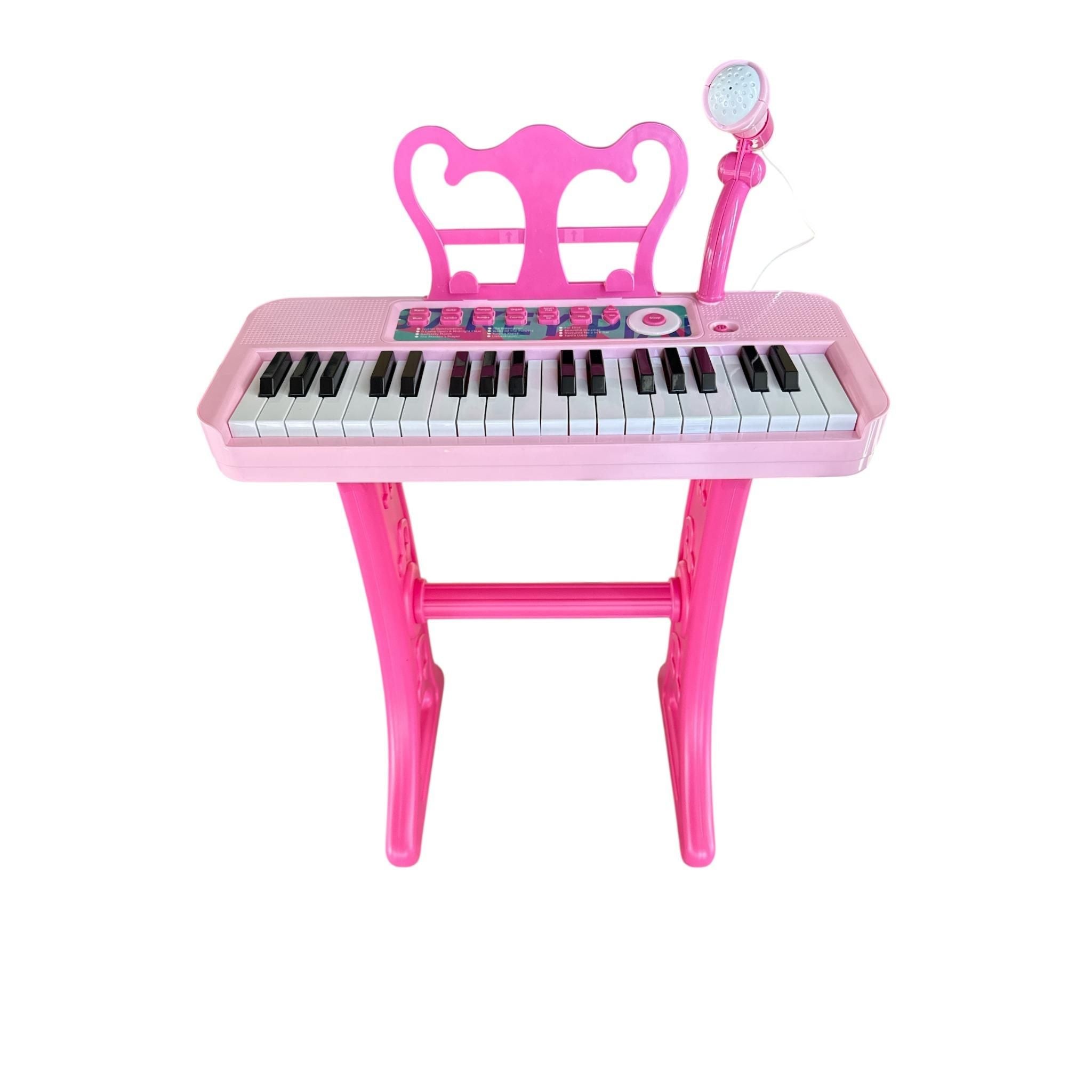 Pink toy keyboard with microphone on a white background