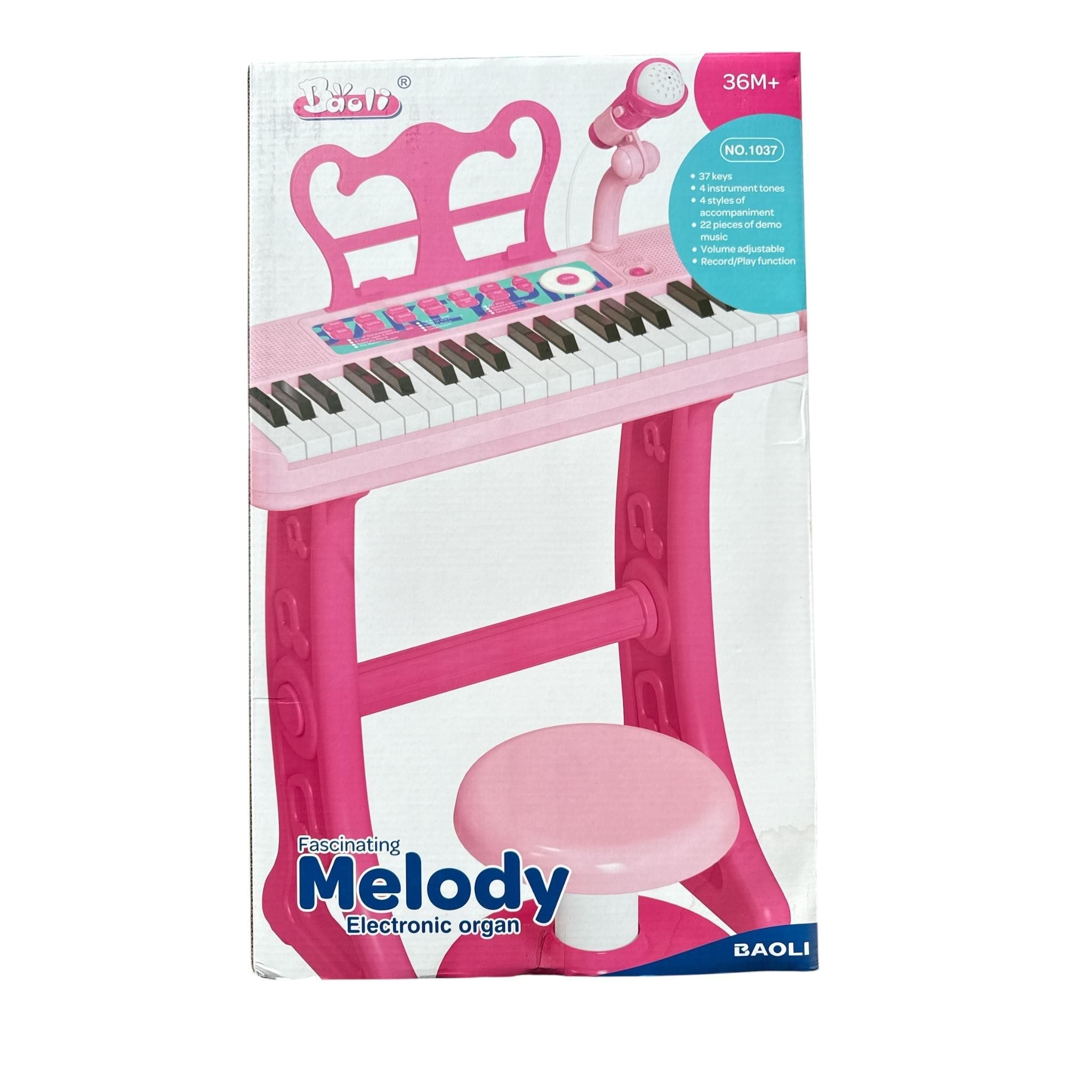 Pink electronic organ with stool and packaging on a white background