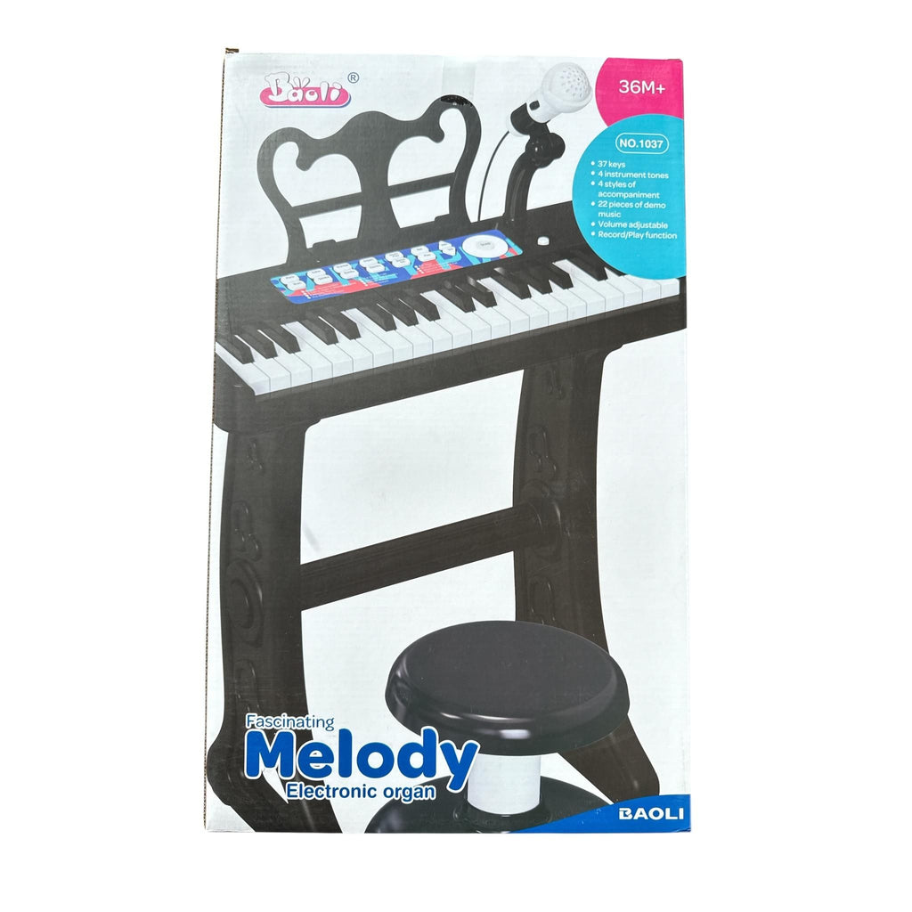 Box of a Melody electronic organ with a stool on a white background