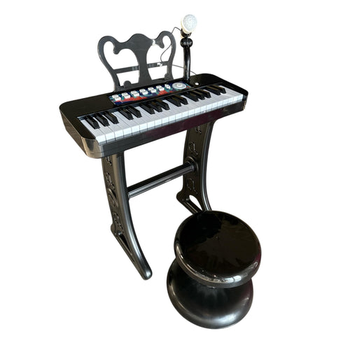 Children's keyboard with chair and lamp on a white background