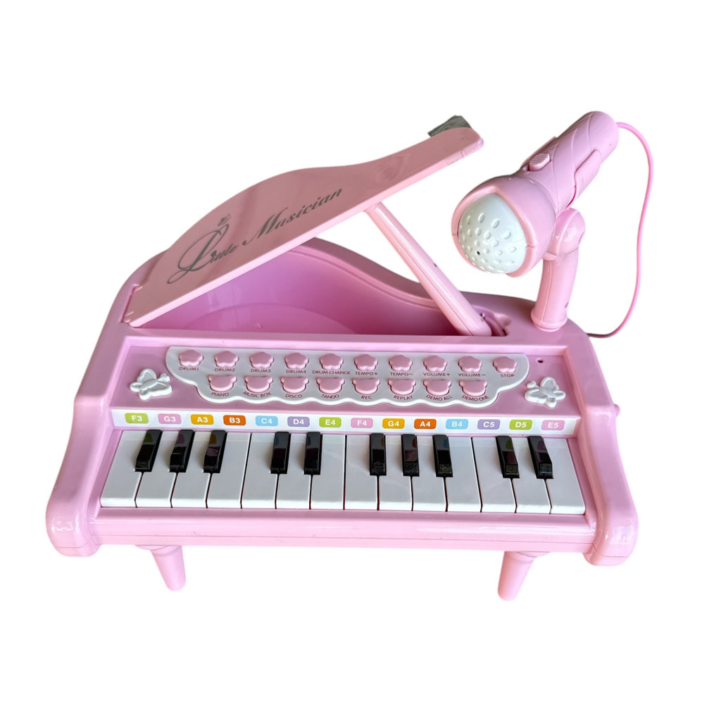 Pink toy piano with microphone on a white background