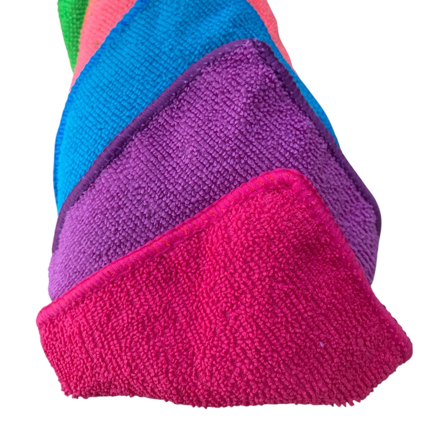 Colorful stack of textured cloths on a white background